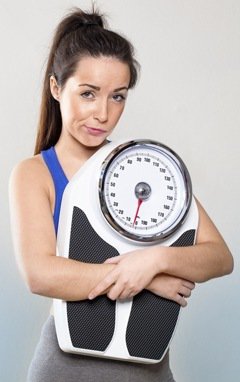 Frustrated Brunette Holding a Scale