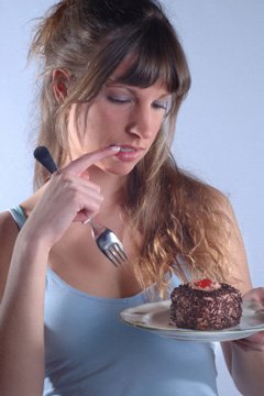 Woman Looking At Piece of Cake